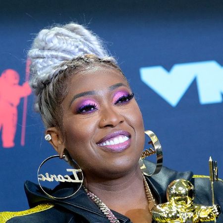 Missy Elliott in a black jacket poses for a picture.